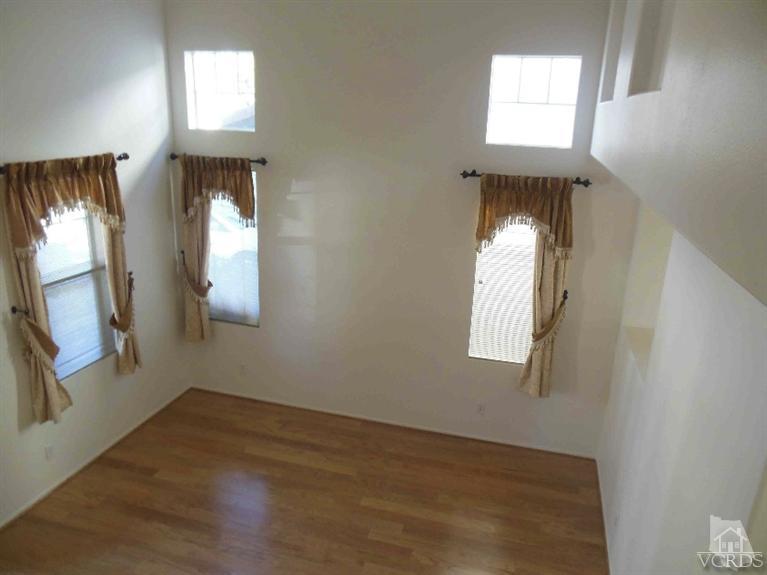 1146 Azalea Way Simi Valley, CA 93065 - Photo 5 of 22 an empty room with wooden floor and windows
