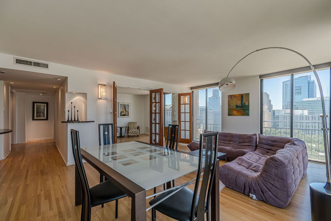 a living room with furniture and wooden floor