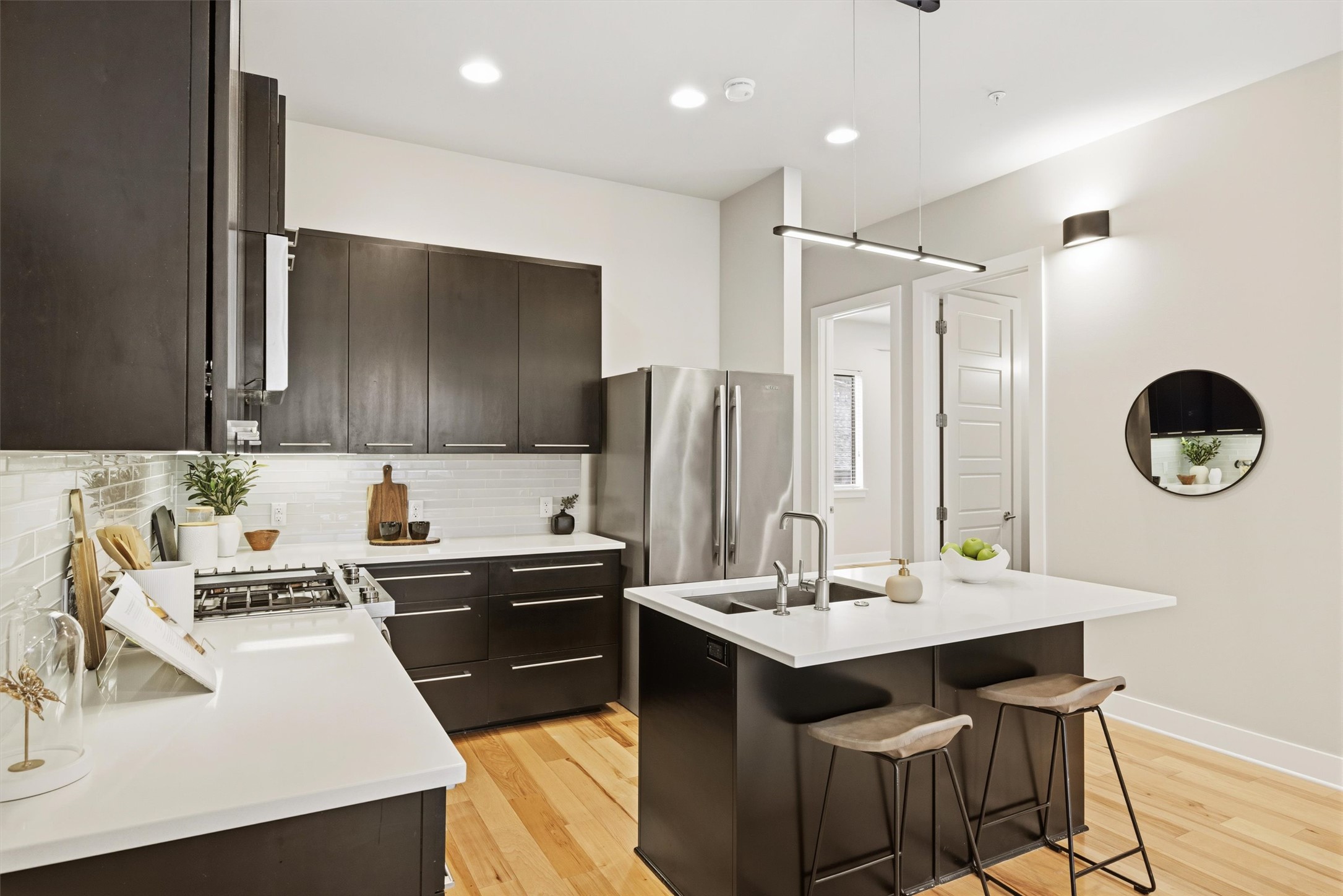 2314 Enfield Road, Unit 203 Austin, TX 78703 - Photo 5 of 37 Under-cabinet task lighting and premium hardware elevate every surface in the kitchen.