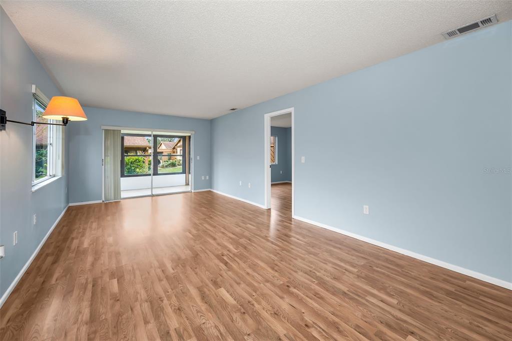 4014 Davit Drive, Unit A New Port Richey, FL 34652 - Photo 11 of 49 a view of empty room with wooden floor and fan