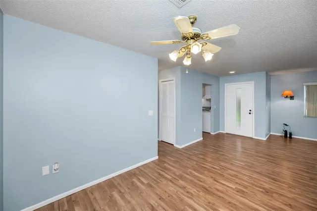 a kitchen with cabinets wooden floor and stainless steel appliances