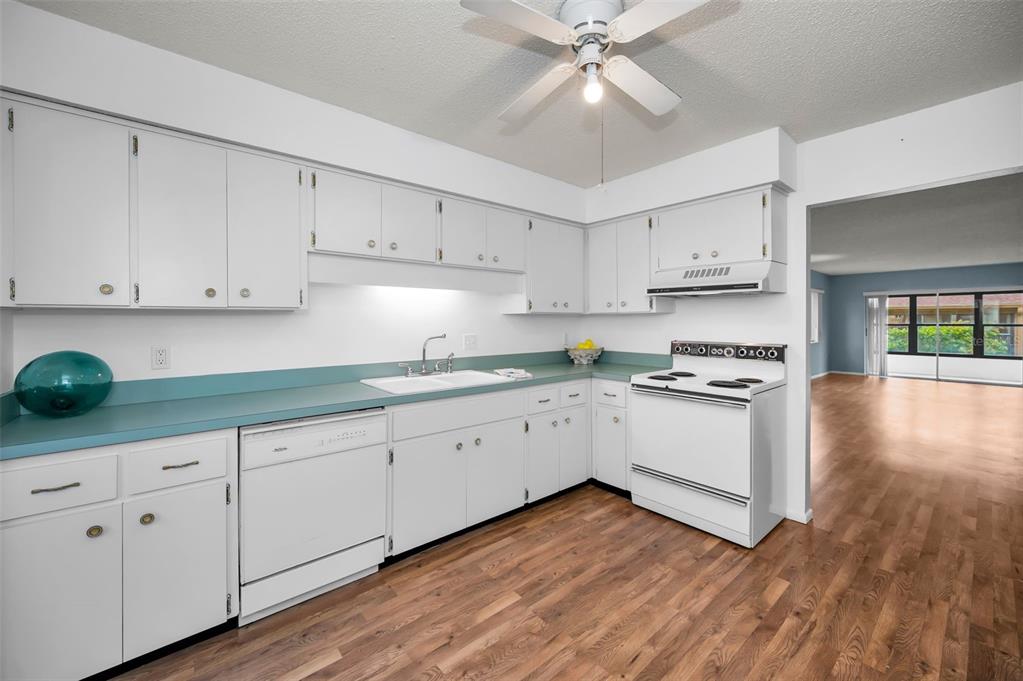 4014 Davit Drive, Unit A New Port Richey, FL 34652 - Photo 17 of 49 a kitchen with cabinets wooden floor and stainless steel appliances