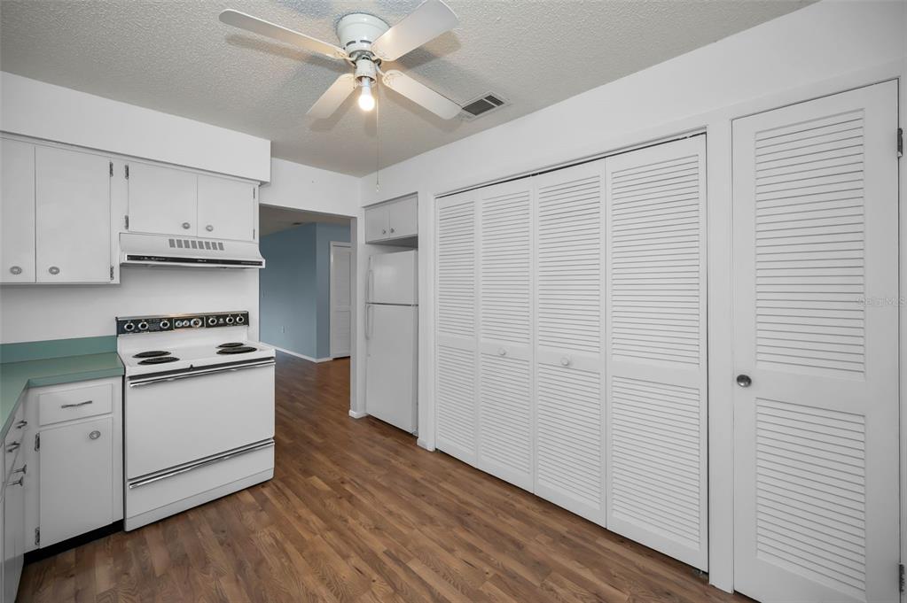 4014 Davit Drive, Unit A New Port Richey, FL 34652 - Photo 18 of 49 a kitchen with cabinets and wooden floor