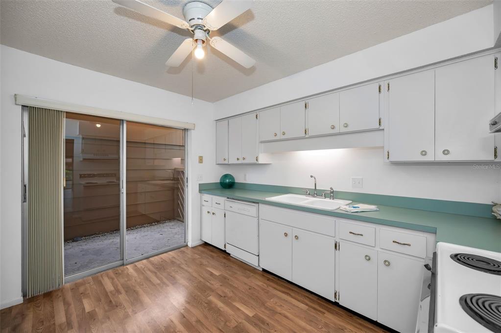 4014 Davit Drive, Unit A New Port Richey, FL 34652 - Photo 23 of 49 a kitchen with granite countertop a sink cabinets and stainless steel appliances