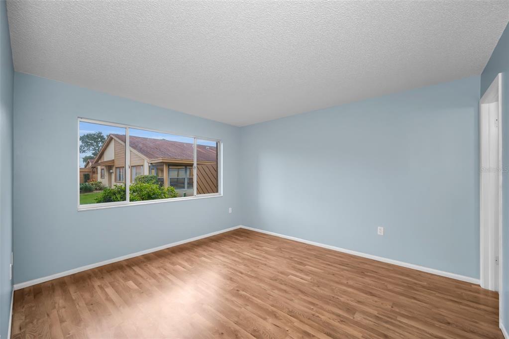 4014 Davit Drive, Unit A New Port Richey, FL 34652 - Photo 24 of 49 a view of an empty room with wooden floor and a window