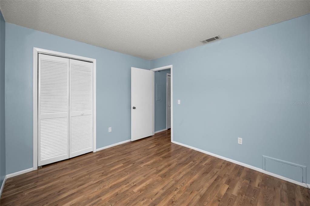 4014 Davit Drive, Unit A New Port Richey, FL 34652 - Photo 29 of 49 a view of an empty room with wooden floor