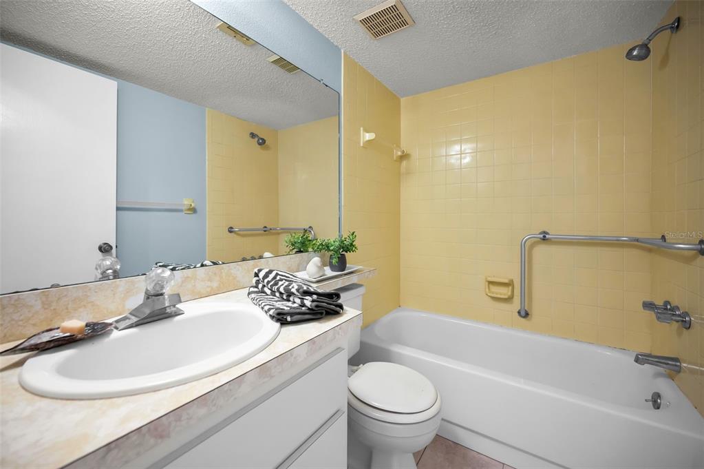 4014 Davit Drive, Unit A New Port Richey, FL 34652 - Photo 30 of 49 a bathroom with a granite countertop sink and a mirror