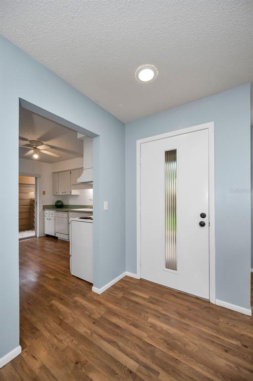 4014 Davit Drive, Unit A New Port Richey, FL 34652 - Photo 5 of 49 a view of empty room with wooden floor and kitchen
