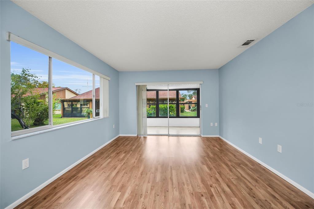 4014 Davit Drive, Unit A New Port Richey, FL 34652 - Photo 7 of 49 a view of an empty room with wooden floor and a window