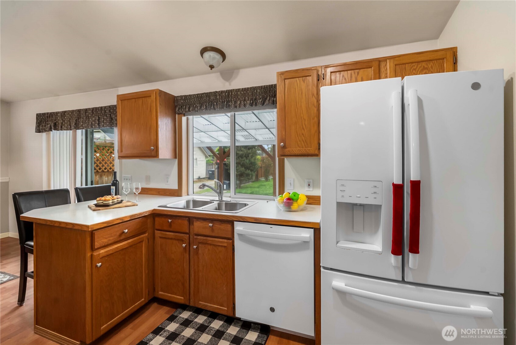 1010 Academy Street Sumner, WA 98390 - Photo 17 of 37 a kitchen with a sink a refrigerator and window