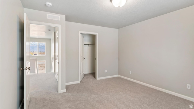 82 Provo River Road, Unit 251 Saratoga Springs, UT 84045 - Photo 23 of 32 Carpeted room with light gray walls, a white ceiling, and a flush mount light fixture