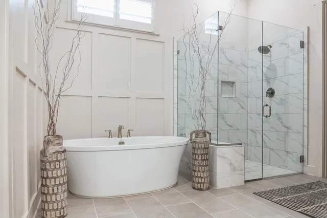 a white bath tub sitting next to a white sink