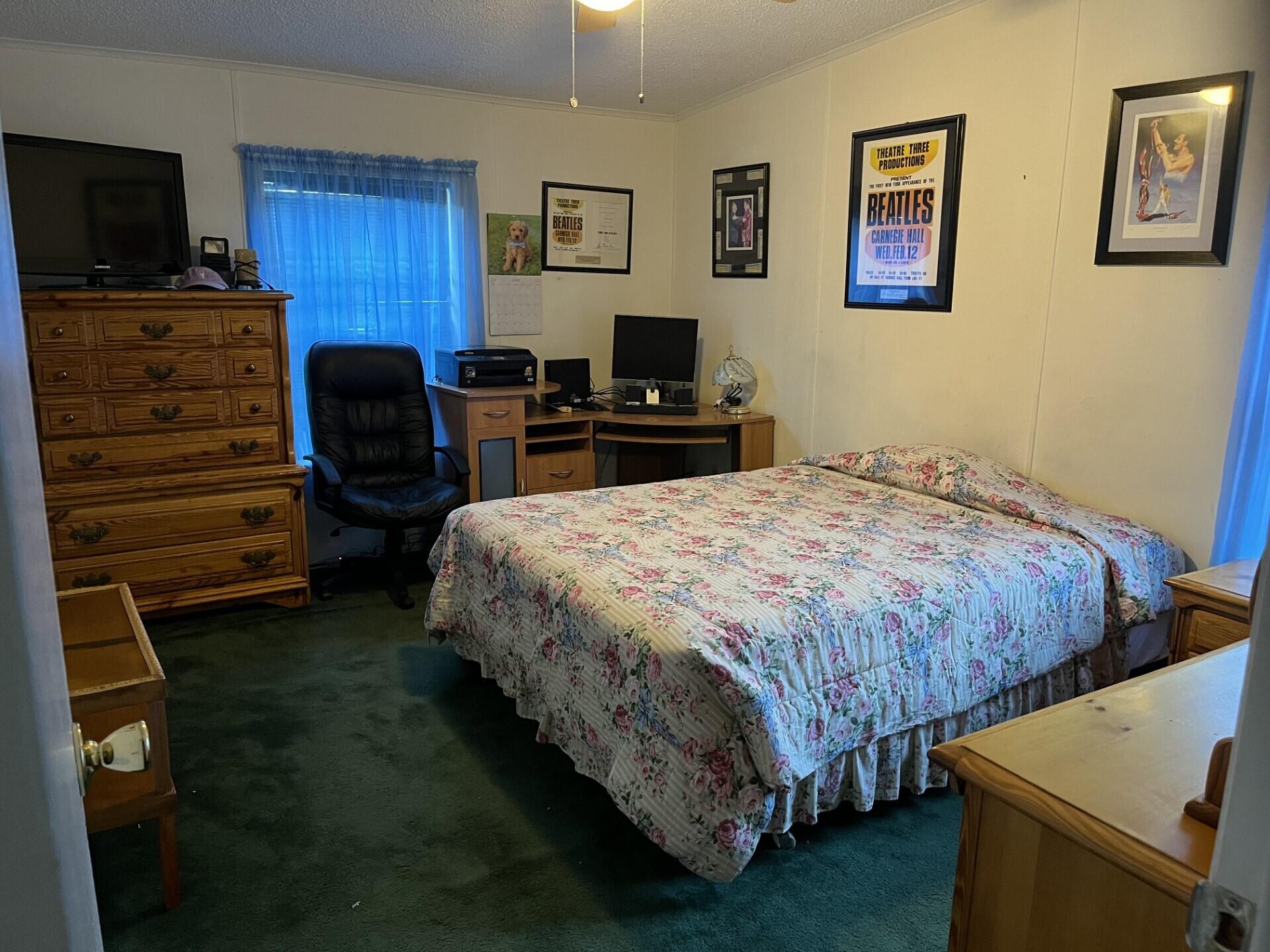 6325 Southeast Colonial Drive Stuart, FL 34997 - Photo 8 of 8 a bedroom with a bed and wooden floor