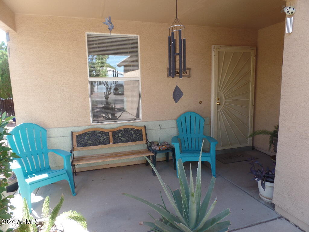 1873 West Renaissance Avenue Apache Junction, AZ 85120 - Photo 1 of 18 a balcony with chairs and a potted plant
