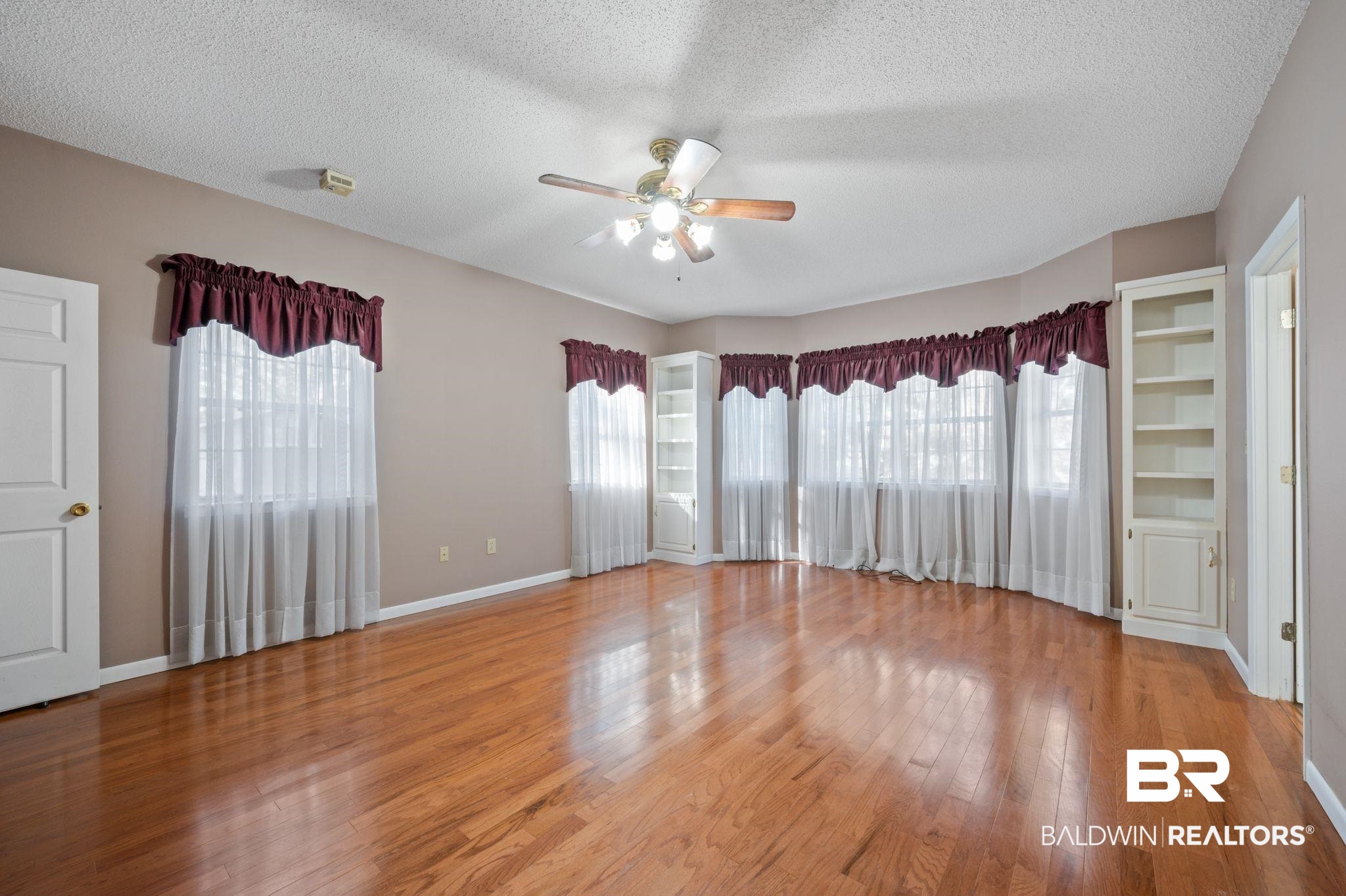 15801 Maytower Road Bay Minette, AL 36507 - Photo 11 of 43 Spare room with ceiling fan, hardwood / wood-style floors, and a textured ceiling