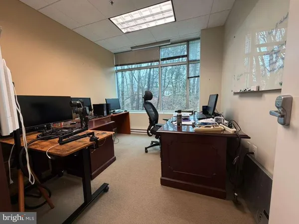 a bedroom with a workspace