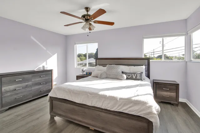 a bedroom with a bed a window and closet