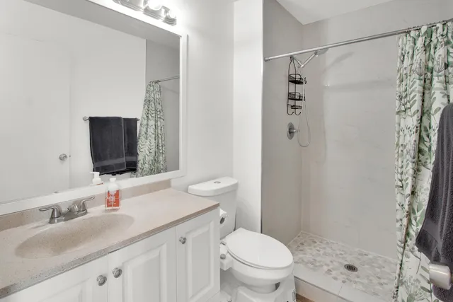 a bathroom with a sink toilet and shower