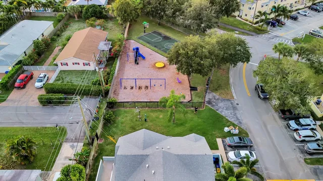 an aerial view of house with yard and swimming pool
