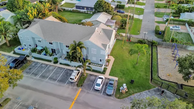 an aerial view of a house with swimming pool and sitting area