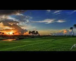 a view of a house with a garden and lake view