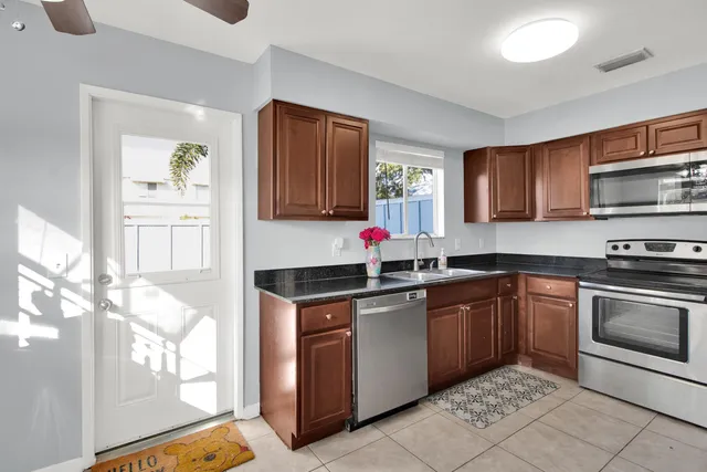 a kitchen with stainless steel appliances granite countertop a stove sink and cabinets