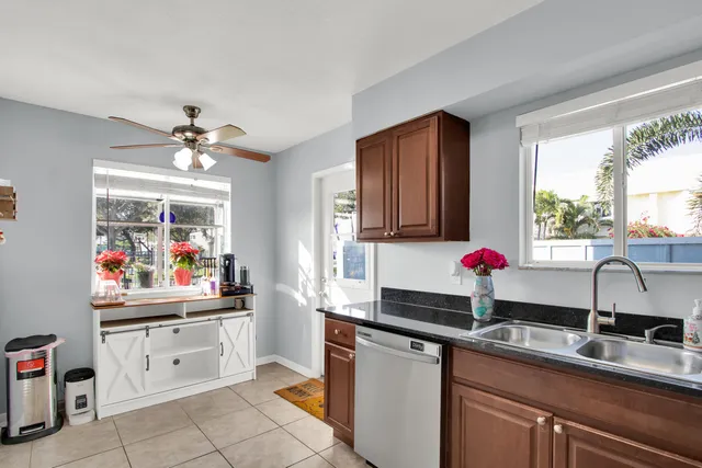 a kitchen with a sink cabinets and window