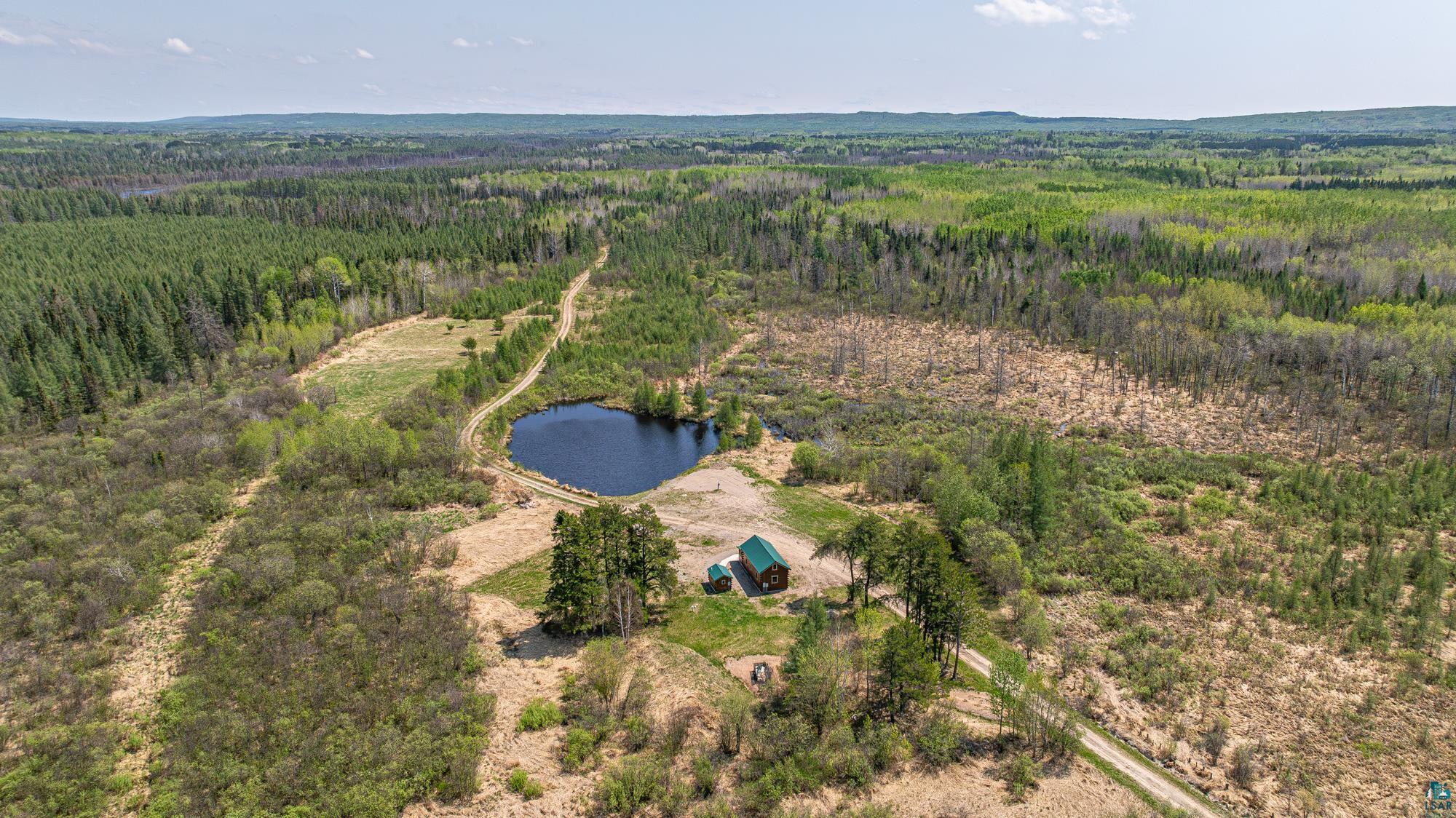 7766 Kaunonen Lake Road Embarrass, MN 55732 - Photo 31 of 50 Aerial overview of property's location featuring a heavily wooded area and a large body of water