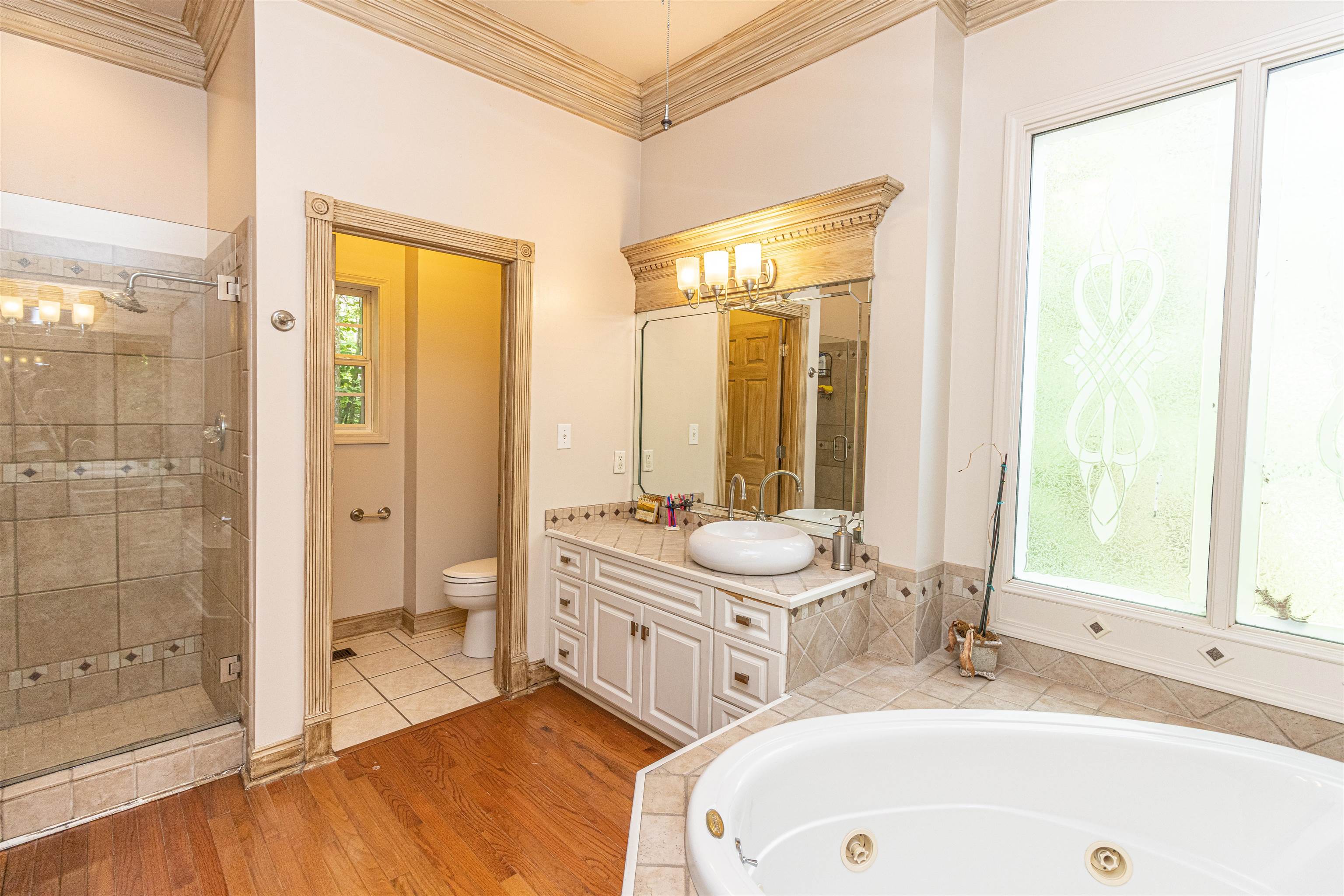 3501 Blue Bird Lane Corinth, MS 38834 - Photo 13 of 25 a bathroom with a tub a sink and a large mirror