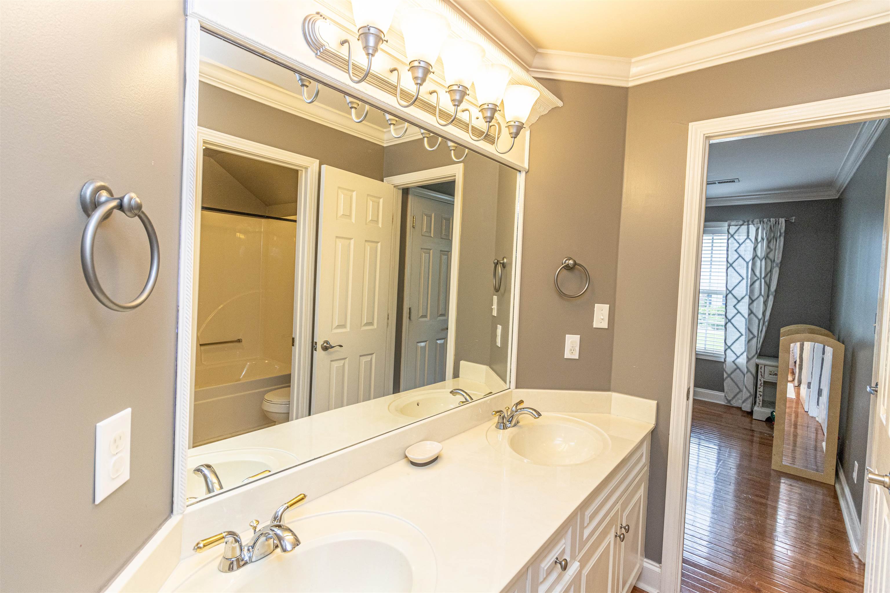 3501 Blue Bird Lane Corinth, MS 38834 - Photo 19 of 25 a en suite bathroom with a double vanity sink and a mirror