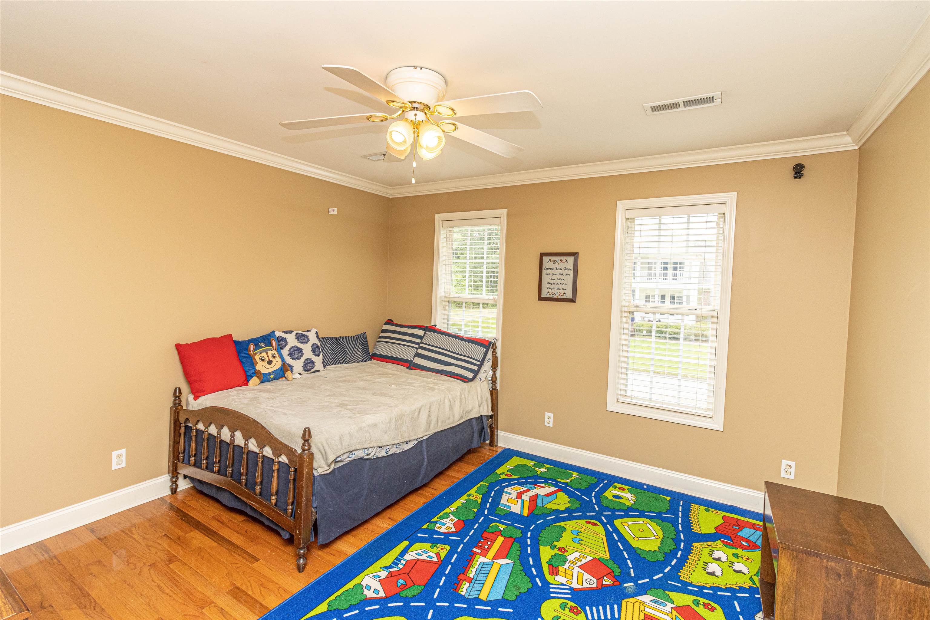 3501 Blue Bird Lane Corinth, MS 38834 - Photo 21 of 25 a bedroom with a bed and a chandelier
