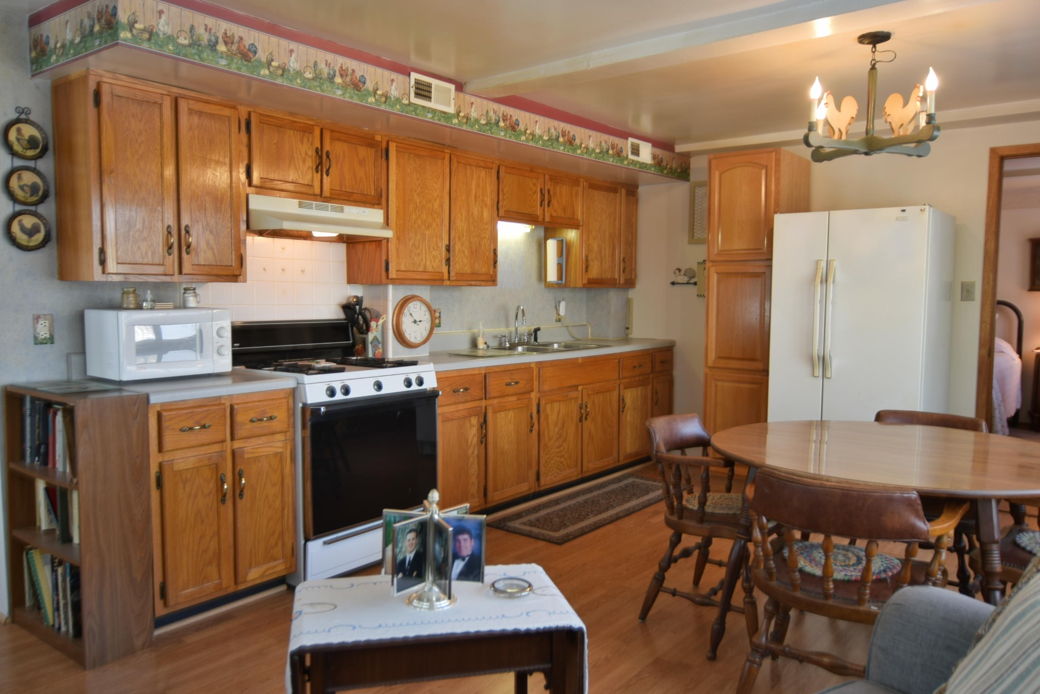 2338 Bear Creek Road Oneida, TN 37841 - Photo 28 of 40 a kitchen with a table chairs refrigerator and cabinets
