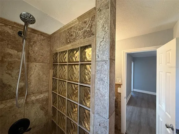 a bathroom with a shower and a sink