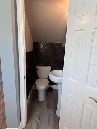 a white toilet sitting next to a sink