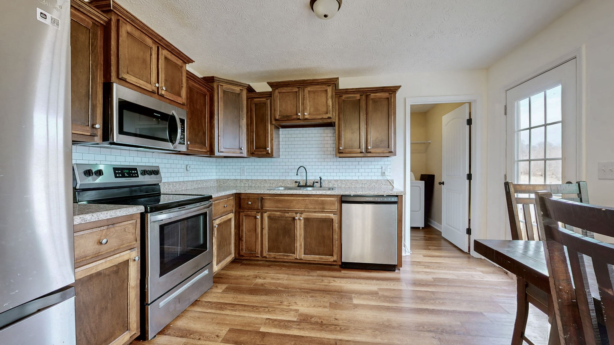 574 Keytown Road Portland, TN 37148 - Photo 15 of 45 a kitchen with stainless steel appliances granite countertop a stove a sink and a microwave
