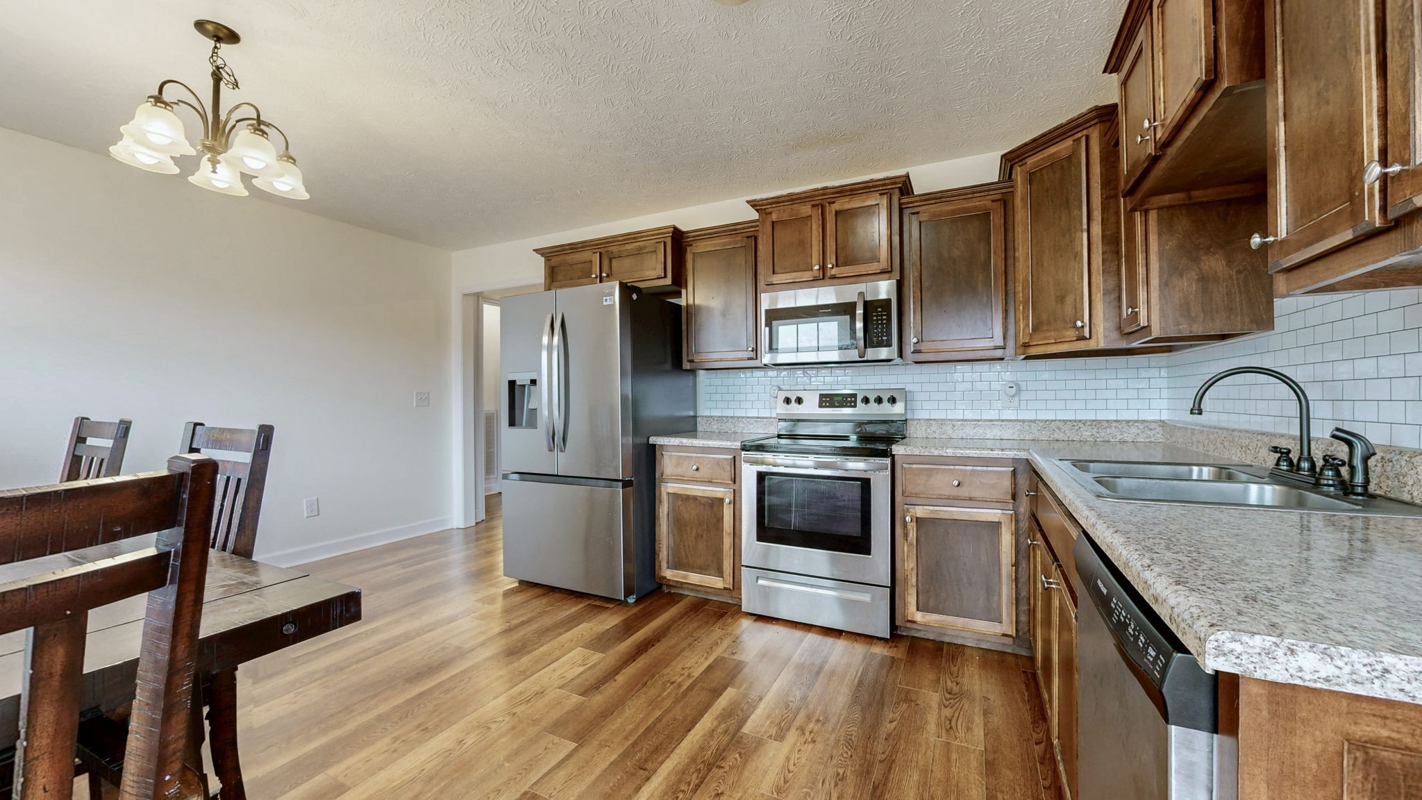 574 Keytown Road Portland, TN 37148 - Photo 16 of 45 a kitchen with stainless steel appliances granite countertop a sink stove and refrigerator