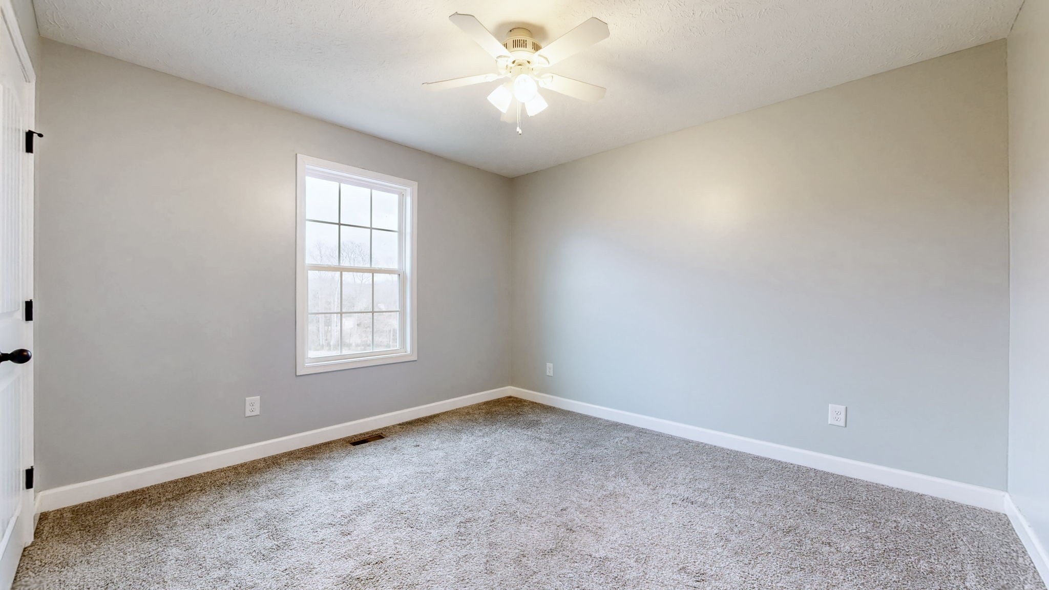 574 Keytown Road Portland, TN 37148 - Photo 31 of 45 an empty room with a window and a fan