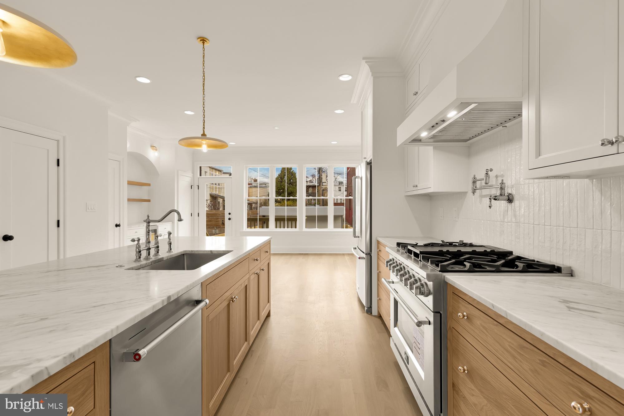 1010 I Street Northeast Washington, DC 20002 - Photo 13 of 51 a kitchen with stainless steel appliances granite countertop a sink a stove and a wooden floors