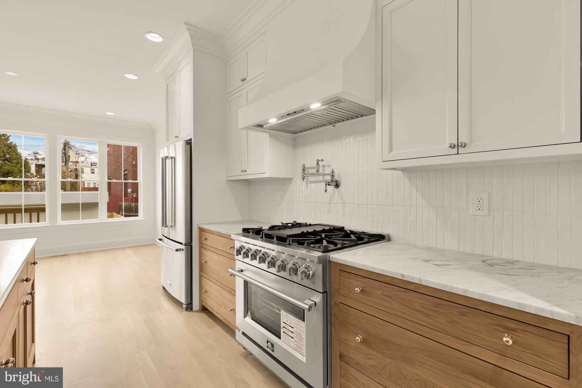 1010 I Street Northeast Washington, DC 20002 - Photo 14 of 51 a kitchen with stainless steel appliances granite countertop a stove and a white cabinets