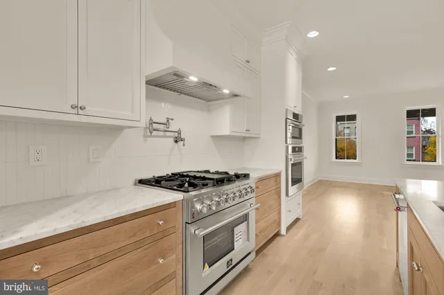a kitchen with granite countertop a stove and a sink
