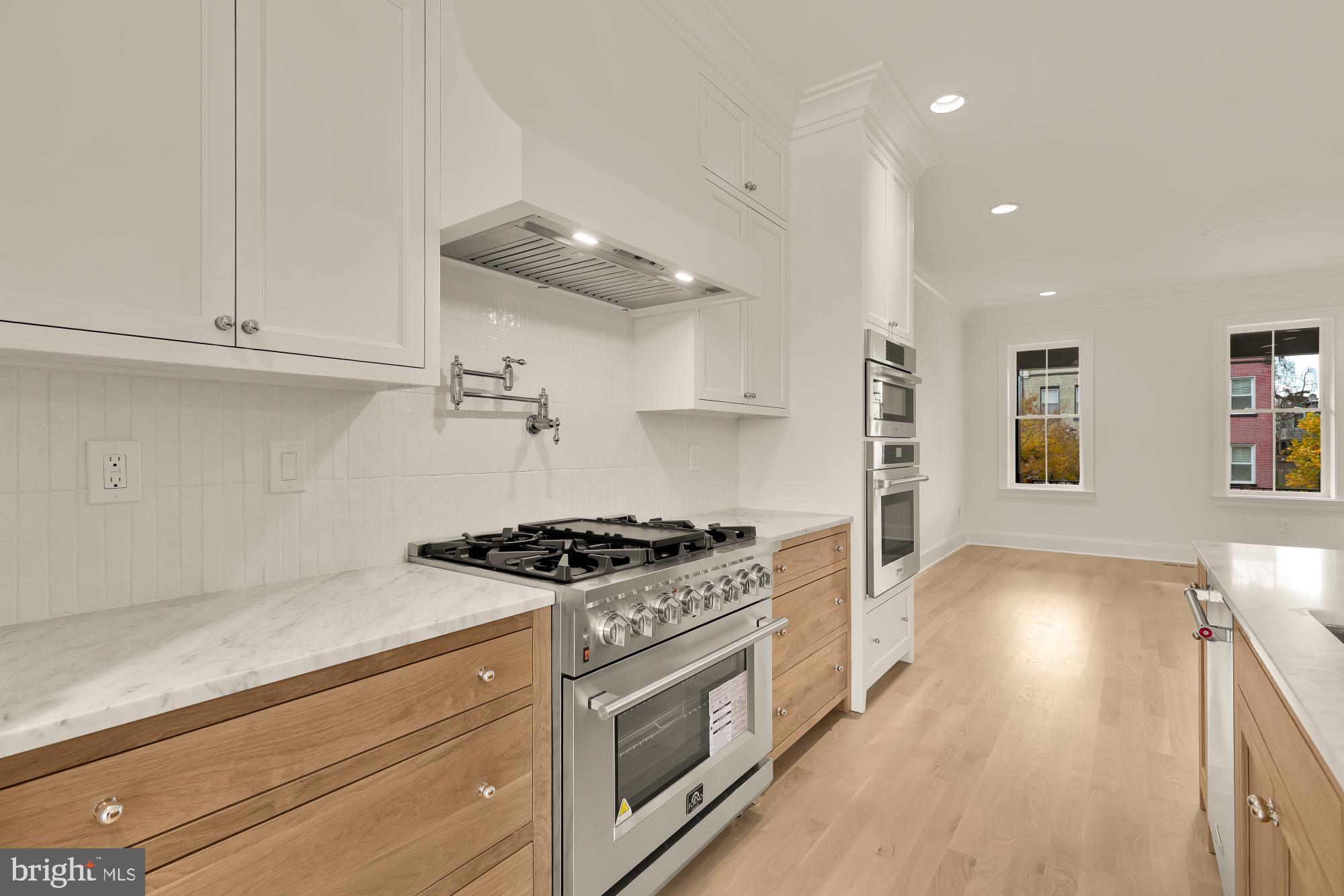 1010 I Street Northeast Washington, DC 20002 - Photo 15 of 51 a kitchen with granite countertop a stove and a sink