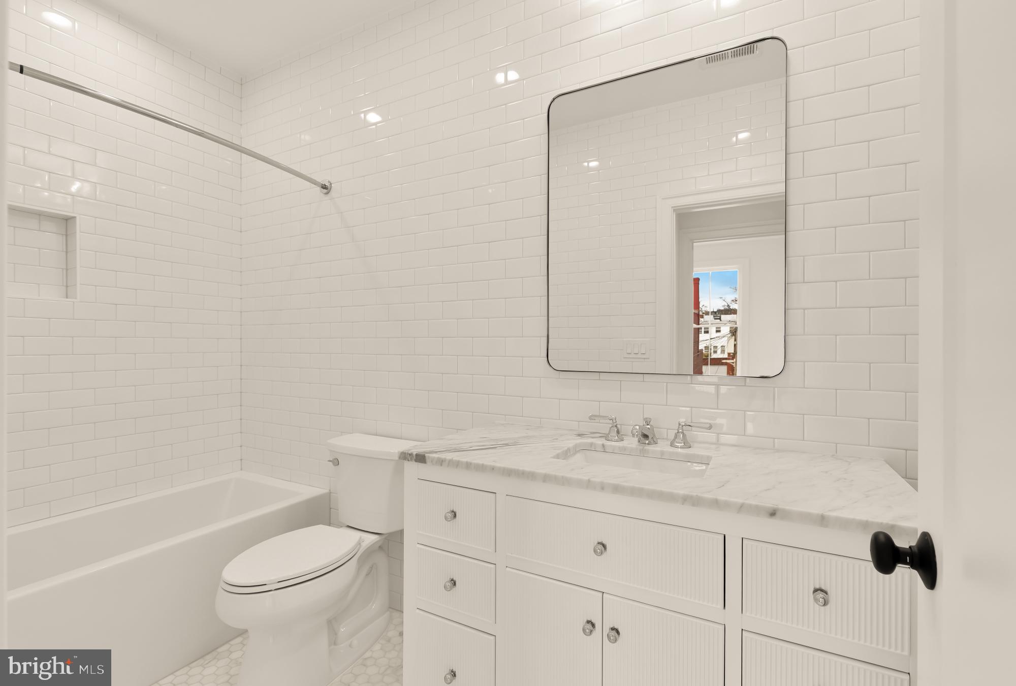 1010 I Street Northeast Washington, DC 20002 - Photo 34 of 51 a bathroom with a granite countertop toilet a sink and a bathtub