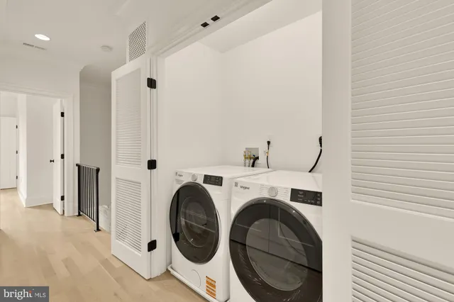 a view of a storage & utility room with dryer and washer