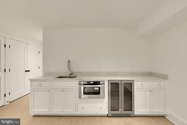 a kitchen with stainless steel appliances granite countertop a sink and a granite counter tops
