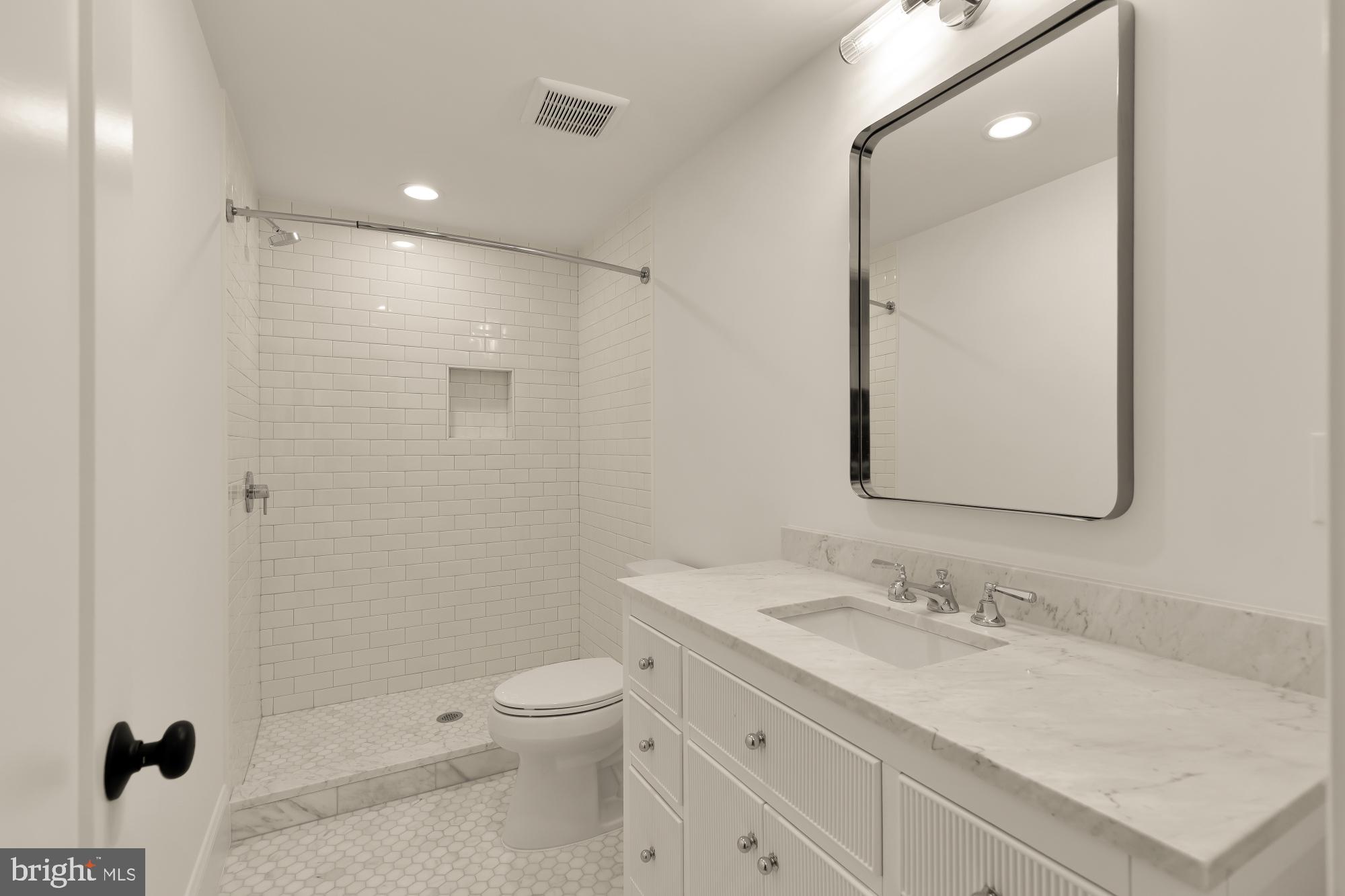 1010 I Street Northeast Washington, DC 20002 - Photo 41 of 51 a bathroom with a sink toilet vanity and shower