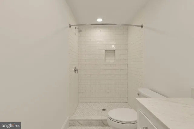 a bathroom with a shower a toilet and sink