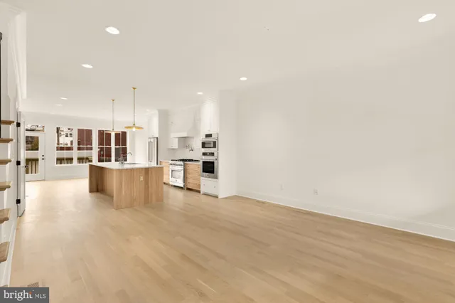 a view of a kitchen with kitchen island and a wooden floor