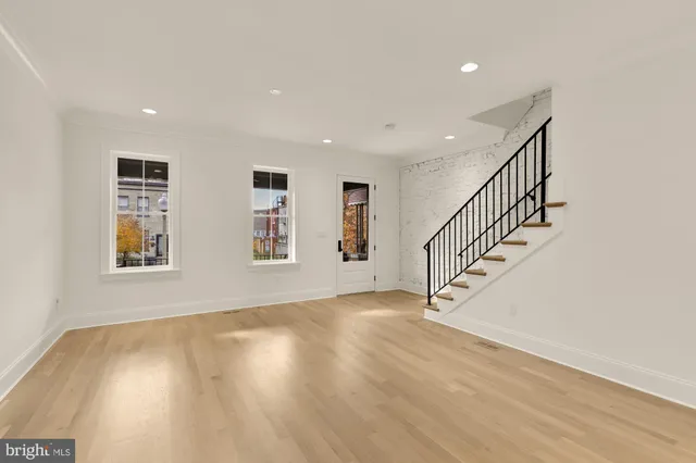 a view of entryway and hall with wooden floor