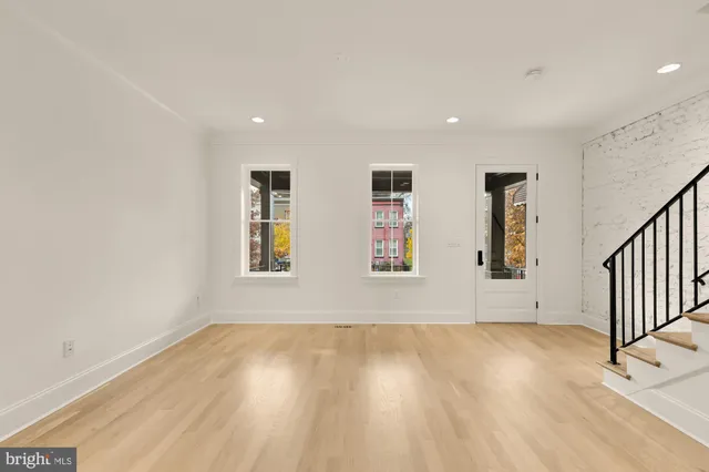 a view of wooden floor and windows in a room