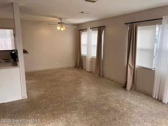 an empty room with windows and closet
